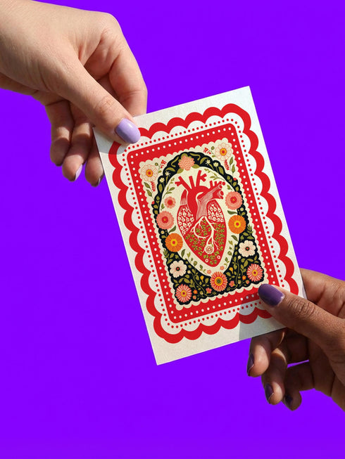 Realistic anatomical heart illustration printed in high contrast ink on a premium 5x7 inch shimmery pearlescent greeting card. The biological heart drawing features detailed arteries, veins, and ventricles, styled with a vintage medical or folk art aesthetic. The cardstock has a visible iridescent sheen. Blank inside valentine card shown with a white peel and seal envelope. Perfect for gothic decor, medical student gifts, cardiology nurse appreciation, and dark academia stationery collections.