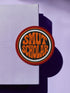 a circular patch with the text "SMUT SCHOLAR" in orange and black colors.