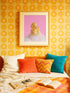 A fine art print of a glamorous rubber duck styled like Marilyn Monroe, with short curled blonde hair and soap bubbles. Displayed in a gold ornate frame against a pink wall with orange bead curtains.