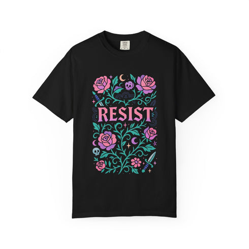 Comfort Colors 1717 unisex garment-dyed t-shirt featuring a front floral graphic with the word RESIST in pink block letters surrounded by green vines, purple roses, skulls, moons, and daggers. Made of soft-washed 100% ring-spun cotton with tubular knit construction, available in sizes S to 4XL.