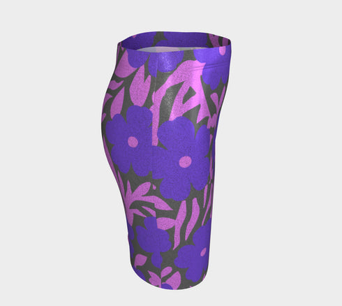 High waisted mini skirt with bold purple and pink floral print in a vibrant, maximalist style. Features a sculpted, body-hugging fit with a 1.5-inch elastic waistband that sits comfortably at the natural waist. Made from eco polyester and spandex blend that is stretchy, quick-drying, odor-resistant, and includes UPF 50 UV protection. Available in standard or glittery metallic finish in sizes S to XL.