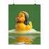 A fine art print of a rubber duck inspired by Marley, featuring black dreadlocks and a red-yellow-green beanie. The duck floats in bath bubbles with its reflection in green-tinted water. Displayed in a white and red frame on a soap-covered shelf in a bold red tile bathroom with a lightning-bolt soap dispenser.