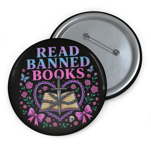 Glossy black pinback button that says “Read Banned Books” in purple and teal letters, featuring a chained book, roses, bows, and floral accents, styled on colorful books and pastel backgrounds.