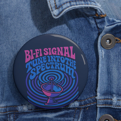 Round pinback button with glossy finish featuring the phrase “Bi-Fi Signal Tune Into the Spectrum” in pink and blue psychedelic lettering, with a satellite dish graphic, available in 2-inch and 3-inch sizes.