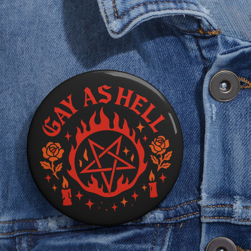 Round glossy pinback button measuring 2.25 inches with bold red graphic design on a black background. Text reads “Gay As Hell” above a red pentagram surrounded by flames, stars, roses, and candles. Made of tinplate with a safety pin back and a scratch-resistant mylar finish. The button features a high-gloss surface and is lightweight and durable, perfect for jackets, bags, or accessories.