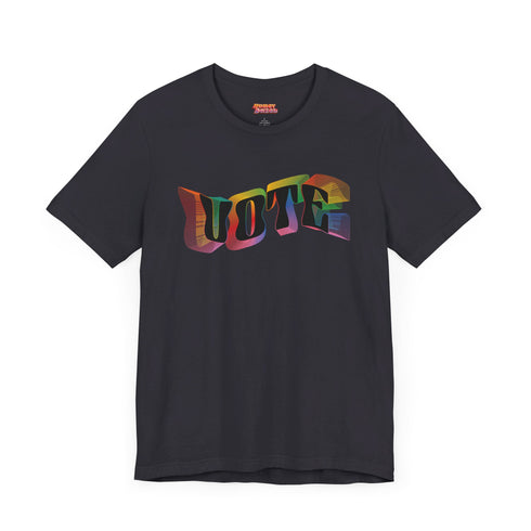Election 2024 t-shirt with "VOTE" printed in large, colorful letters. Each letter features a different color from the rainbow spectrum, styled in a groovy 70s-inspired font.