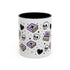 The Gothic Read Dangerously Mug Accent Coffee Mug (11, 15oz) features a glossy white finish, black interior, and playful designs of purple books, skulls, hearts, stars, and a "Read Dangerous!" book—perfect for book-loving rebels. BPA-free.