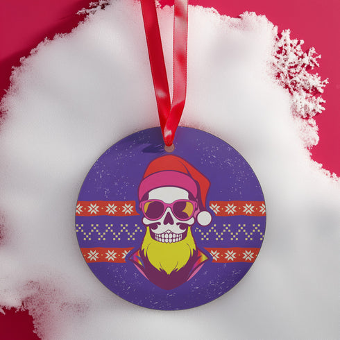 Round purple metal Christmas ornament featuring skull wearing sunglasses and Santa hat with neon yellow beard, surrounded by Nordic-style pattern bands in red and yellow.