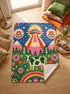 A rectangular velveteen minky blanket with a bright, maximalist design. The top half features a vibrant blue sky with a pink, green, and yellow UFO beaming rays down over hot pink snow-capped mountains. The bottom half shows a grassy green field with a white cow covered in dark spots, surrounded by large, colorful red, pink, and blue retro flowers, pine trees, and a rainbow arch at the very bottom. The reverse side is a fluffy off-white sherpa.