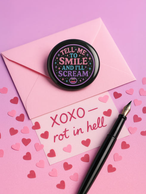 a pen and a button on a pink background