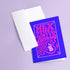 A vertical 5x7 greeting card made from premium 120lb silk cover stock with a slight sheen. The card has a deep purple background with a thin pink border. In the center, the words 'Hex the Halls' are written in a bubbly, psychedelic 70s-style font in shades of hot pink and light pink. Below the text is a stylized pink silhouette of a woman's face in profile with long, flowing, wavy hair. The design is reminiscent of retro witchcraft and groovy aesthetics, perfect for an alternative holiday.