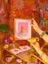 A fine art print of a glamorous rubber duck styled like Marilyn Monroe, with short curled blonde hair and soap bubbles. Displayed in a gold ornate frame against a pink wall with orange bead curtains.