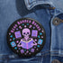 Literary rebel's badge of honor. Black circular button featuring a neon purple skeleton surrounded by floating books and stars. The text 'READ BANNED BOOKS' arcs across the top in bold purple lettering. Perfect for book-loving misfits who devour forbidden knowledge.