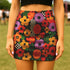 Honey Dazed retro floral mini skirt in a fitted pencil silhouette with high waist. Features a groovy all-over print of oversized flowers, checkers, waves, and bold 70s-inspired shapes in orange, red, purple, green, and yellow. Designed with a soft, sculpting stretch fabric for all-day comfort and drama. A statement piece made for maximalists, festival-goers, and vintage fashion freaks. Perfect for layering with puff sleeves and platform boots.