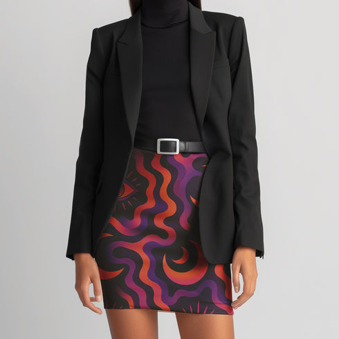 A woman wearing a black blazer and a colorful, abstract skirt.