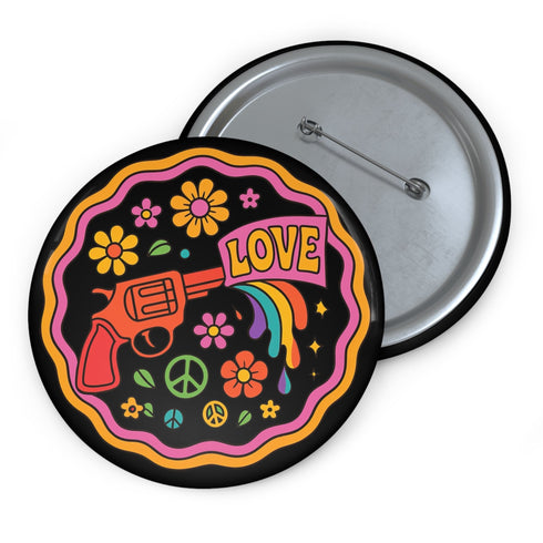 Round pinback button badge with a black background, featuring a retro illustration of a red revolver shooting out a rainbow flag that says “LOVE.” Surrounded by colorful 70s-style flowers and peace signs, outlined in wavy neon border. Glossy finish with vibrant pop colors and psychedelic design.