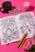 A 8.5 by 11 inch softcover coloring book titled The Feminist Rage Coloring Book For Cute Loud Unhinged Women. The black cover features vibrant pink and green typography, a fanged heart engulfed in flames, pink roses, and crescent moons. The back cover displays a heart pierced by a dagger and text reading Your feelings are valid your rage is too. Inside pages contain black and white line art with bold feminist quotes, floral borders, potions, coffins, and edgy witchy illustrations.