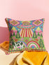 Description of a square throw pillow with a vibrant maximalist alien design. A central UFO with a large all-seeing eye hovers above a landscape with two rainbows, pink mountains, and green pine trees. A black and white spotted cow stands in the foreground. The design is a high-contrast palette of sky blue, magenta, hot pink, and meadow green. The pillow has a faux-embroidery 2D print finish on linen-feel fabric, framed by a yellow and pink scalloped floral border.