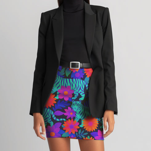 Honey Dazed tiger floral mini skirt in a neon jungle print with electric blue stripes, violet flowers, and lush tropical leaves. This fitted pencil silhouette is made with performance eco-polyester and hugs the body with a smooth, curve-enhancing stretch. High-waisted and fierce, this design channels wild energy, retro rave vibes, and maximalist jungle glam. A fearless standout piece for festival nights and bold daytime slayage.