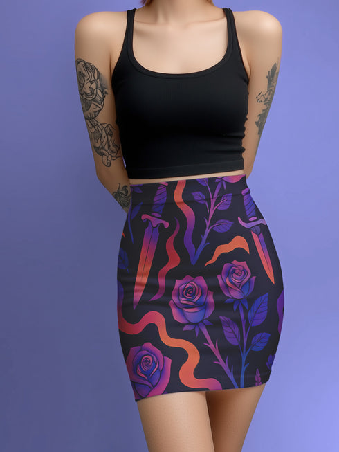 High-waisted mini skirt with dark botanical print featuring violet roses, fiery orange daggers, and swirling ribbon-like accents on a black background. Form-fitting silhouette with stretch eco-poly fabric and elastic waistband. Available in metallic glitter or smooth finish. A bold look for gothic, witchy, or alternative festival fashion.