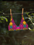 Tropical tiger print bikini top with bold pink, yellow, and teal psychedelic pattern. Scoop neck cut with wide straps, double-layered fabric, UPF 50+, and removable padding. Made from soft, stretchy recycled polyester and spandex.
