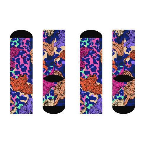 Stylish jungle-themed socks with tigers and abstract camo patterns in a palette of purple, blue, and pink, laid out on a yellow background, ideal for adding a pop of color to your wardrobe