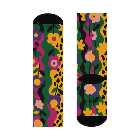 Colorful dopamine-infused crew socks with an all-over print featuring abstract flowers and leopard spots in bold hues of pink, purple, yellow, green, and black. Made of plush polyester-spandex blend, with black toe and heel accents. Designed to fit women’s US 5 to men’s US 12 shoe sizes.