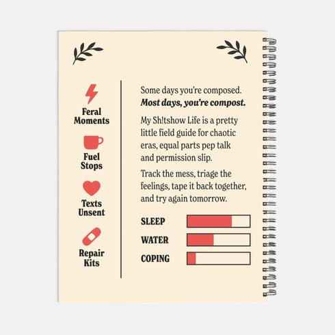 An 8.5 x 11 inch hardcover spiral-bound planner with a cream-colored cover featuring red and black folk art style floral illustrations. The cover reads "My Sh*tshow Life: A Field Guide" in a retro serif font. The planner has a durable satin matte laminated cover adhered to chipboard and a metal wire-o spiral binding available in gold or black. Interior pages are undated and include monthly and weekly layouts with sections for notes, to-do lists.