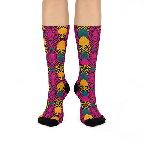Colorful pink tiger print crew socks with black heel and toe, featuring yellow zebra stripes and teal and coral fan-shaped accents. Made of stretchy knit with a bold maximalist aesthetic. One size fits most, mid-calf length, vibrant all-over print