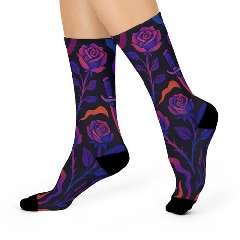 Mid-calf socks with a dark violet-black base featuring a gothic dagger and rose design in gradient shades of red, purple, and pink, with black heels and toes and an illustrated snake detail.