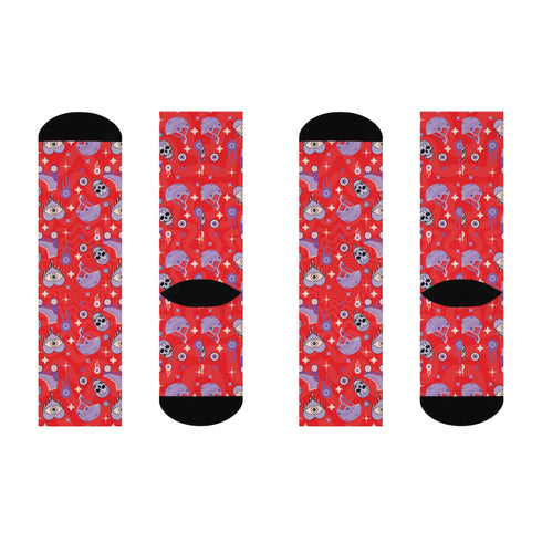Fun and vibrant socks adorned with colorful roller skates, helmets, and wheels motifs on a red background, with black heels and toes, ideal for roller skating enthusiasts.