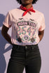A short sleeve unisex crewneck t-shirt featuring a detailed Moon Tide 8647 graphic centered on the chest. The design includes bats, crescent moons, and spiderwebs at the top, with Moon Tide in a dripping font above a large 8647 rendered in shell patterned bubble numbers. The bottom features a skull inside a scallop shell, roses, and a Saltwater Spell banner. The color palette uses mint green, lilac, and salmon pink with black outlines. The shirt is shown in light pink, lavender, and cream.