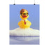 A humorous fine art print of a rubber duck modeled after Dwight Schrute, complete with glasses, mustard tie, and serious expression. Floating in soap suds, the print is framed above a retro bed with bold orange flower wallpaper and bright accent pillows.