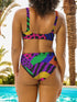 Colorblock animal print bikini top with neon pink, orange, green, purple, and blue abstract pattern. Scoop neck cut with wide straps, removable padding, double-layered fabric, UPF 50+, and made from soft, stretchy recycled polyester-spandex blend.
