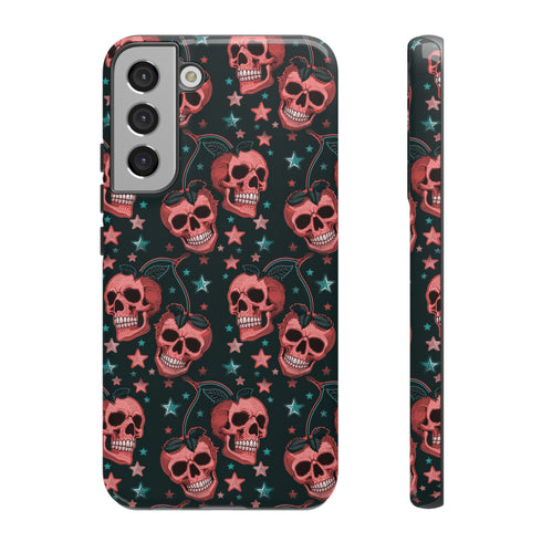 Phone case featuring coral pink apple skulls with green stems and multicolored stars on black background. Gothic alternative design with pastel accents.
