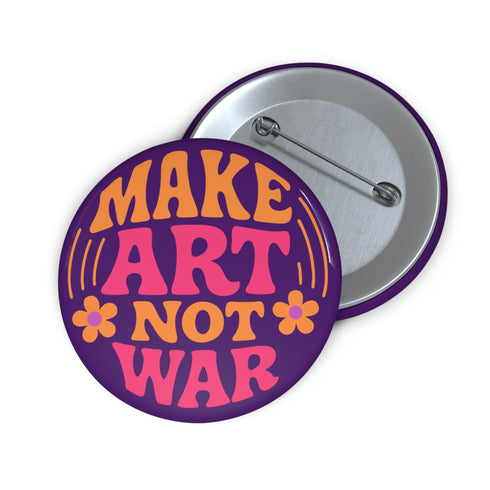 A round, glossy purple pinback button with the words "MAKE ART NOT WAR" in a groovy, retro 70s-style font. The word "MAKE" is in orange, "ART" is in a vibrant pink, and "NOT WAR" is in orange. The text is surrounded by small, stylized flower and star details. This psychedelic protest pin is a piece of activist merch with a strong metal back and safety pin clasp, perfect as an anti-war or social justice accessory for a jean jacket or backpack. The pin has a handmade, indie aesthetic.