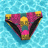 Tropical tiger print bikini bottom with vibrant pink, yellow, and teal psychedelic design. Mid-rise cut with cheeky coverage, double-layered fabric, UPF 50+, and soft, stretchy recycled polyester-spandex blend.