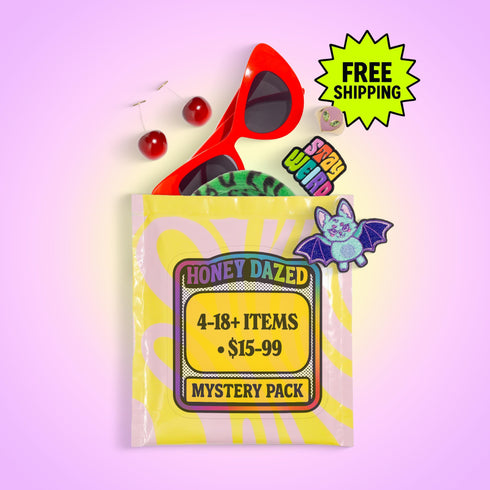 A curated alternative style bundle from Honey Dazed, available as a mystery box gift for her. This aesthetic grab bag is personalized to a chosen vibe, such as goth and pretty, psychedelic groovy, maximalist mayhem, alt skater gremlin, or weirdcore. Each surprise pack contains a high-value assortment of unique items like women's apparel, accessories, jumbo stickers, enamel pins, patches, and alternative home decor. Perfect as a birthday gift, a personalized care package, or a surprise box.