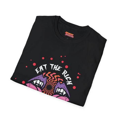 Black t-shirt featuring a surreal, psychedelic design centered on the chest. An open mouth with sharp vampire-like teeth and pink tongue dominates the image. Between the teeth, a hypnotic swirling pattern in rainbow colors leads to a single eyeball on the tongue. "EAT THE RICH" is written in white above the mouth. Red paint-like splatters surround the entire design, giving it a grungy, punk aesthetic. The shirt is from the "Honey Dazed" brand.