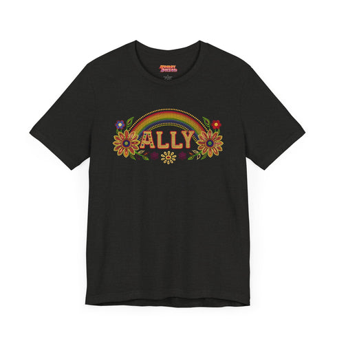 Black unisex t-shirt with "ALLY" in gold lettering under a rainbow arch, flanked by two large sunflower designs. LGBTQ+ pride ally shirt with folk art-inspired elements, available in cotton-poly blend, sizes S-3XL.