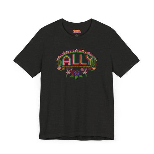 Black t-shirt featuring "ALLY" in gold letters protected by a rainbow arch and flanked by two sunflowers. LGBTQ+ pride ally shirt with colorful folk art-inspired design, available in cotton-poly blend, sizes S-3XL.