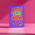 A colorful card with the text "Another Year Stranger" displayed prominently on it.