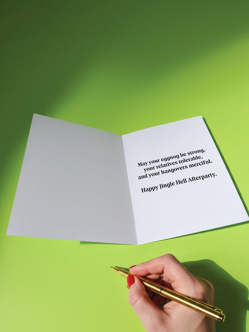 A 5x7 pearlescent shimmer folded greeting card featuring the Jingle Hell Survivors Club design. The front is a illustration of a grumpy red devil imp character, wearing a small Santa hat, holding a coffee cup, and a circular 'I Tried' merit badge. The overall aesthetic is maximalist dark humor and spooky cute. This anti-Christmas card is perfect for those needing relief from holiday stress. Inside text references surviving tolerable relatives, strong eggnog, and merciful hangovers.