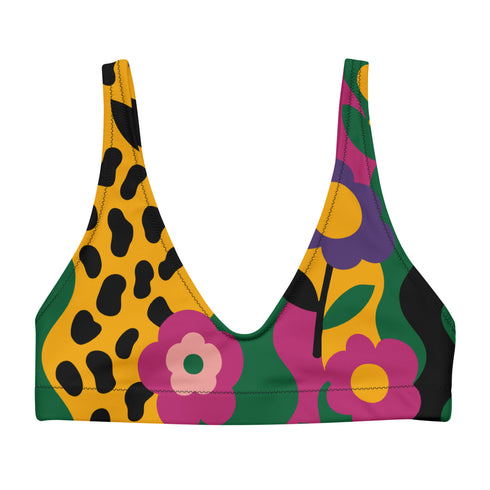 Scoop-neck bikini top with thick straps and a vibrant retro flower print in yellow, pink, green, and black. Features a secure, supportive sports-bra style fit. Shown above a bright turquoise pool, this top channels a maximalist 70s energy with bold color blocking and playful floral design. Ideal for statement swimwear, retro summer fashion, and festival season looks.