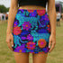 Honey Dazed tiger floral mini skirt in a neon jungle print with electric blue stripes, violet flowers, and lush tropical leaves. This fitted pencil silhouette is made with performance eco-polyester and hugs the body with a smooth, curve-enhancing stretch. High-waisted and fierce, this design channels wild energy, retro rave vibes, and maximalist jungle glam. A fearless standout piece for festival nights and bold daytime slayage.