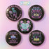 Five glossy 2.25-inch round pinback buttons with pastel punk book-themed designs. Each pin features a different bold phrase like “Read or Die,” “Books Are My Familiar,” and “Give Me Books or Give Me Death,” in pink, purple, and teal colors. Made of tinplate with a safety pin back and glossy scratch-resistant coating.