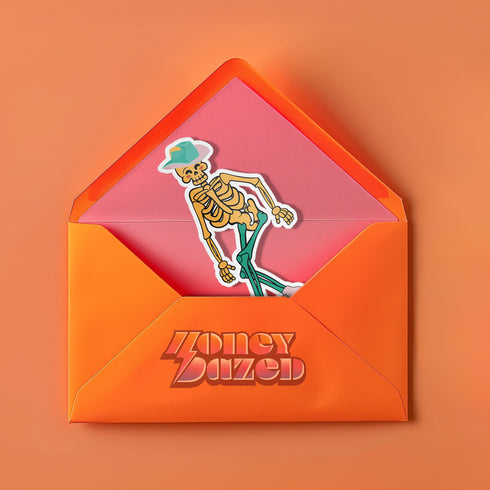 A sticker featuring a whimsical skeleton dressed in a green cowboy hat, casually posed with one leg propped up. The skeleton sports a full grin and is adorned with vibrant teal and orange roller skates, adding a playful and surreal touch to the design.