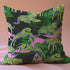 Square pillow cover featuring neon chartreuse tigers with cobalt blue stripes lounging among emerald green palm fronds on a black background with pink geometric accents.