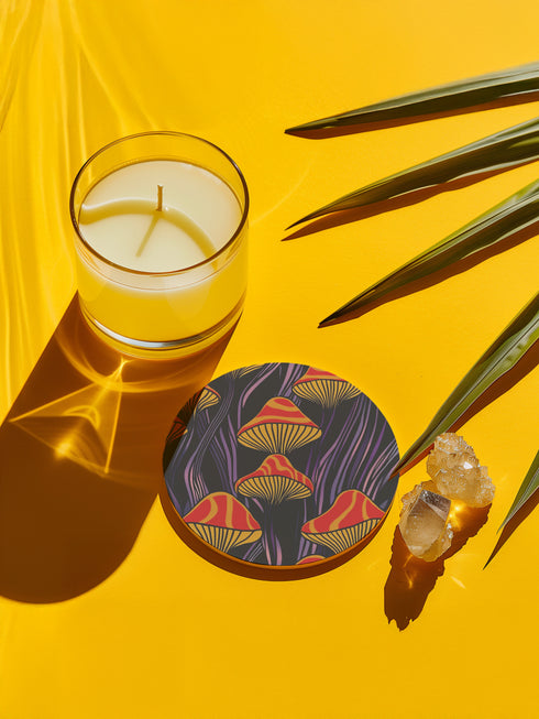 Round ceramic coaster featuring orange and yellow mushrooms with striped caps against a dark background with flowing purple lines in a psychedelic 70s style