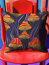 Square pillow cover featuring a bold retro pattern of orange and red striped mushrooms with yellow gills against a navy background with flowing purple lines.
